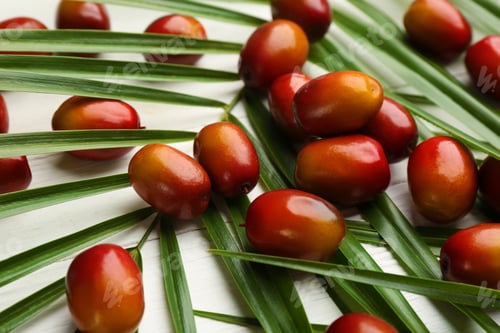 Preview: Palm oil fruits on white wooden table, closeup