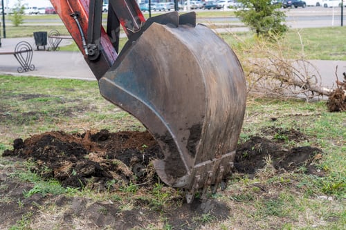Preview: Excavator work. The iron ladle digs into the ground. Digging a hole.