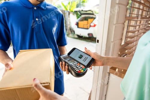 Preview: Close up of delivery man delivering package to female customer at home.