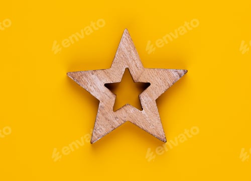 Preview: Christmas star decor on yellow colored background.