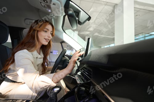 Preview: Joyous female picking out new car at auto dealership