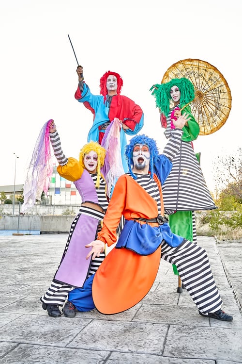 Preview: Excited clowns performing various tricks during festive event in park
