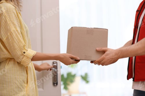 Preview: Woman receiving parcel from deliveryman on blurred background, closeup. Space for text