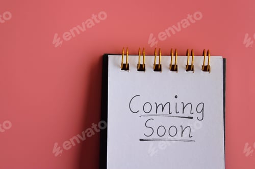 Preview: A notepad with the handwritten phrase "Coming Soon" on a bright pink background.