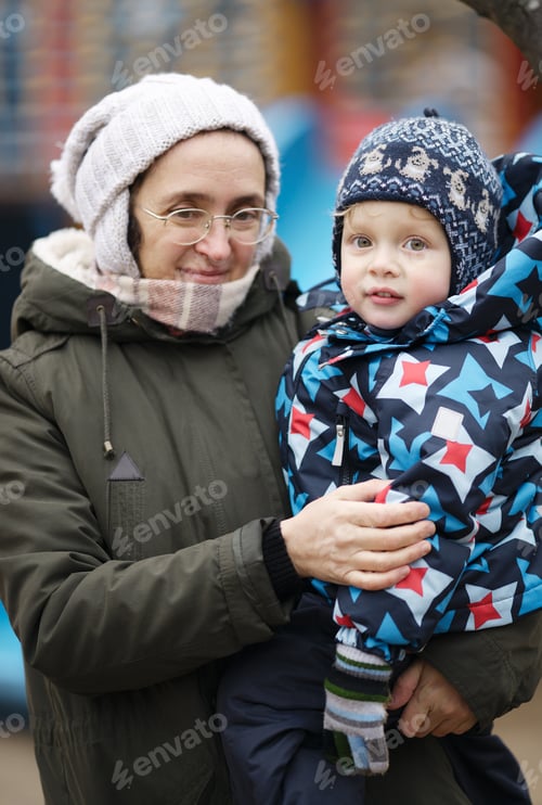 Preview: Woman holding her small son