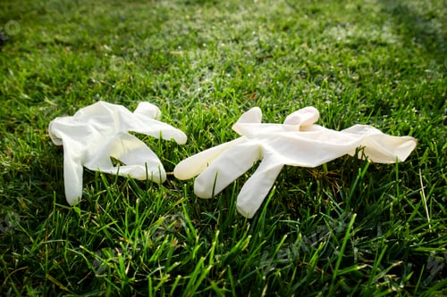 Preview: Disposable anti Coronavirus gloves thrown on the ground