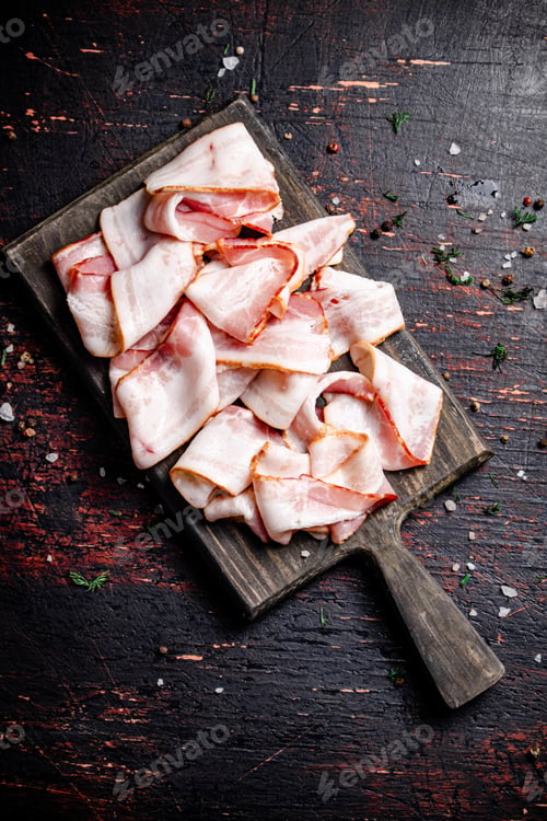 Preview: Strips of bacon on a cutting board.
