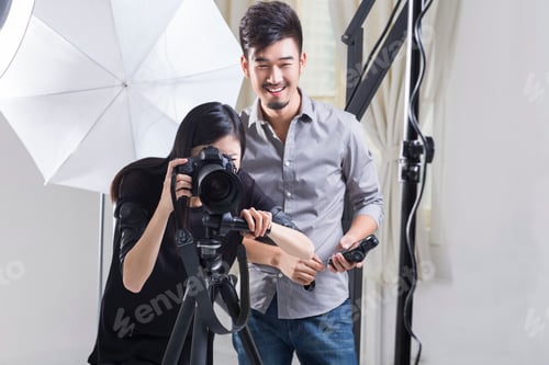 Preview: Two photographers working in studio