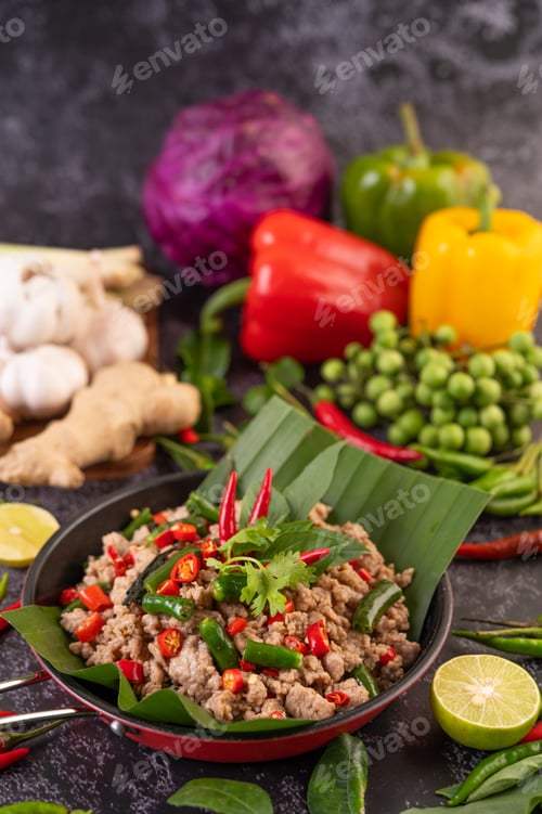 Preview: Stir-fried pork basil on banana leaves in a frying pan.