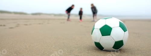 Preview: Close up of soccer ball with three people