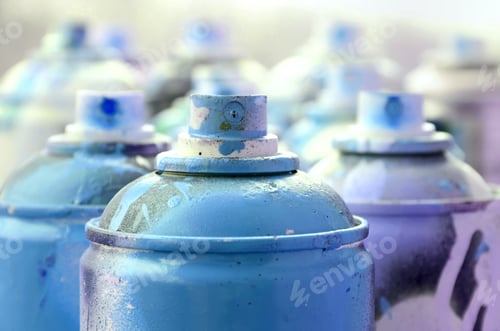 Preview: A lot of dirty and used aerosol cans of bright blue paint. Macro photograp