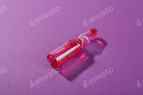 Preview: Glass ampoule with liquid on purple background