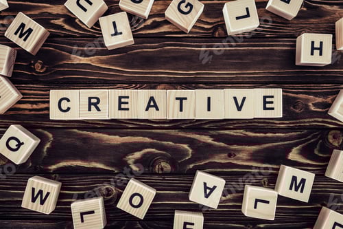 Preview: flat lay with blocks arranged in creative word on brown wooden surface