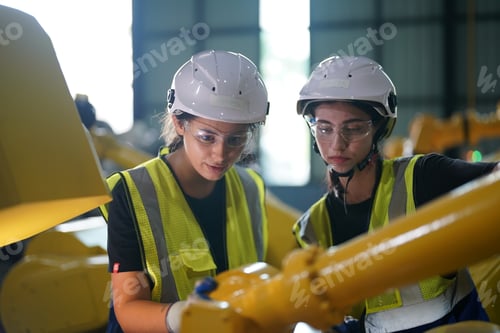 Preview: Robotics engineer working on maintenance of robotic arm in factory warehouse. Business technology.