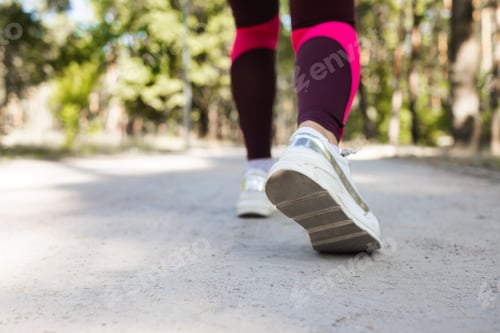 Preview: Young fitness woman runner runner on the road. Fitness and workout wellness concept.