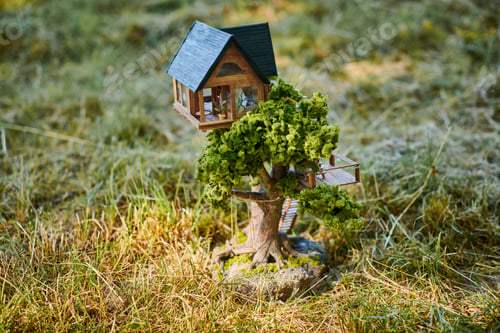 Preview: Little dollhouse on front lawn, cute small decorative house on green grass field, copy space
