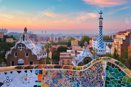 Preview: Barcelona city view from Guell Park. Sunrise view of colorful mosaic building in Park Guell