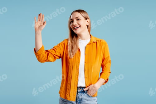 Preview: Cheerful young woman waving arm, greeting, expressing welcome and friendly gesture