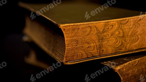 Preview: Close up of vintage thick book lying on flat surface isolated on black background. Stock footage