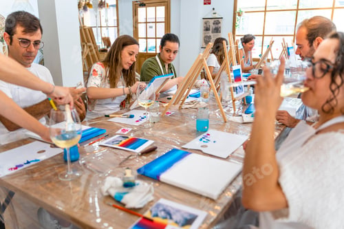 Preview: Painting Workshop. Group of friends painting and drinking white wine.