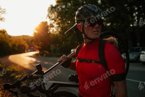 Preview: Man and dog in backpack on bike tour in forest