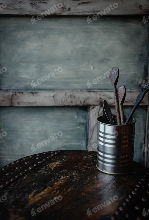 Preview: close up view of wooden cutlery in metal can on dark wooden tabletop