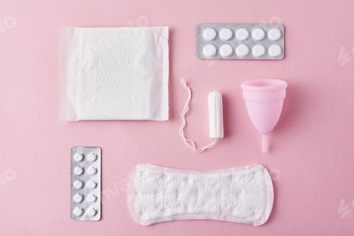 Preview: Sanitary pad, menstrual cup, tampon and tablets on a pink background, top view