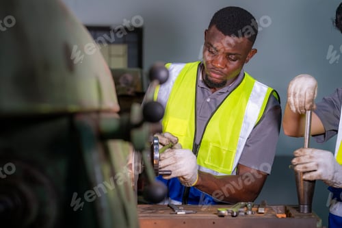 Preview: Skilled worker focused on operating machinery in a factory