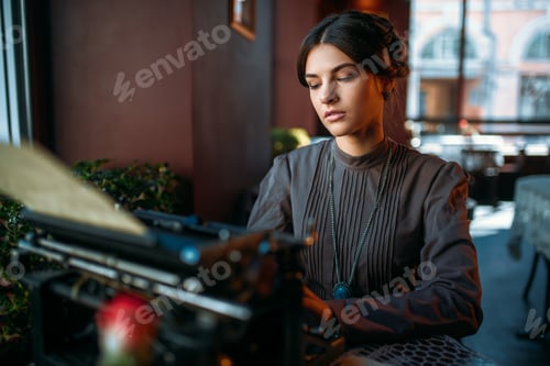 Preview: Serious lady prints on ancient typewriter