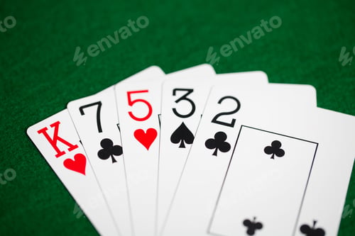 Preview: poker hand of playing cards on green casino cloth