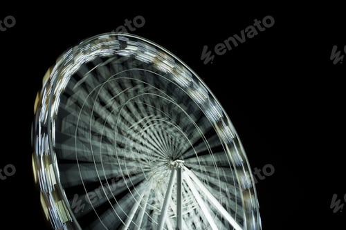 Preview: selective focus of defocused observation wheel at night on black background