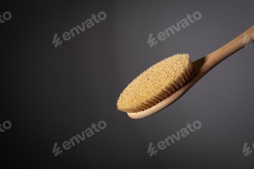 Preview: wooden brush for body dry massage anti cellulite peeling body care. on dark background Close-up