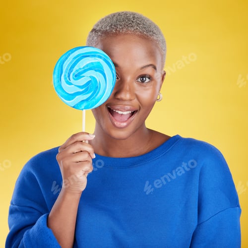 Preview: Excited, portrait and black woman with a lollipop in studio for dessert, sweet treat or craving. Ha