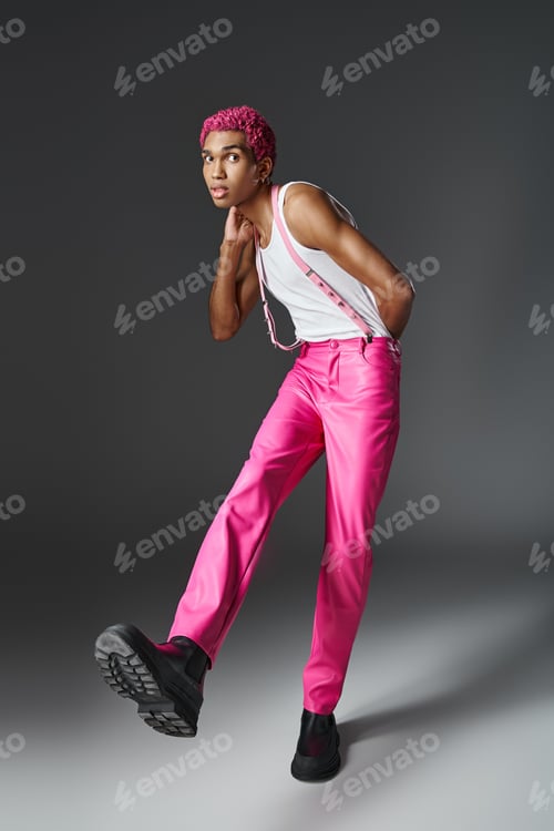 Preview: stylish pink haired man in pink pants with suspenders and black boots with laces, fashion and style