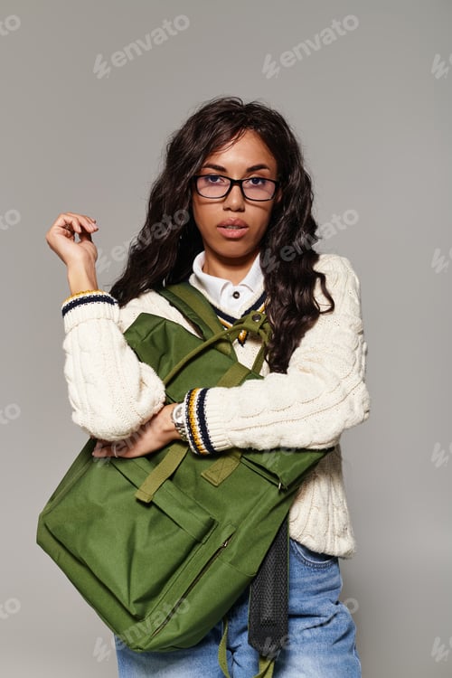 Preview: Young woman embodies student aesthetics with a stylish vibe in cozy attire and chic accessories