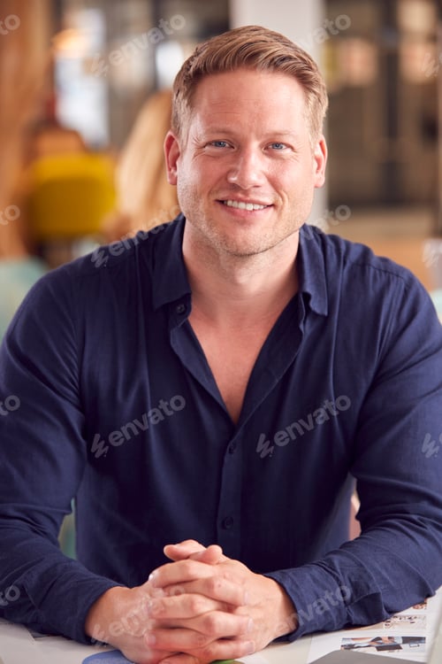 Preview: Portrait Of Smiling Businessman Working On Table In Office Coffee Shop