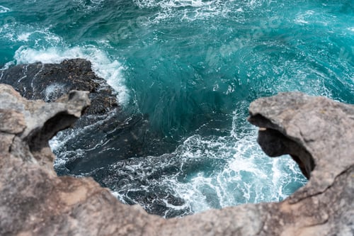 Preview: Looking over a cliff face, down to the ocean waves, Australia
