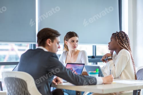 Preview: Diverse colleagues gather in brainstorm discuss statistics together.