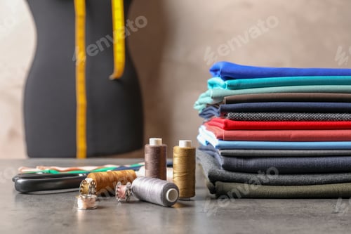 Preview: Dressmaking Equipment and Colorful Fabrics on a Table