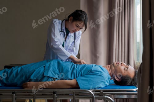 Preview: Doctor Examining Patient Lying on Hospital Bed