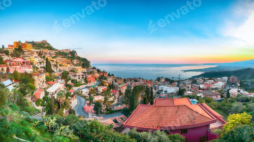 Preview: Aquamarine blue waters of sea and fantastic cityscape of Taormina during sunset