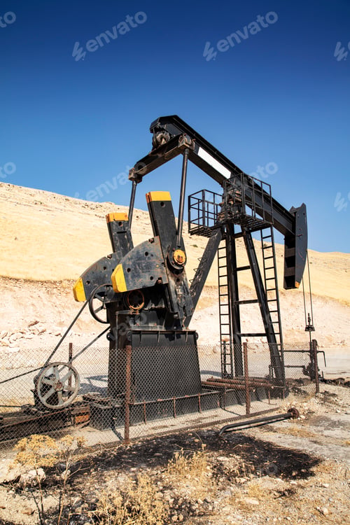 Preview: Oil drilling derricks at desert oilfield.