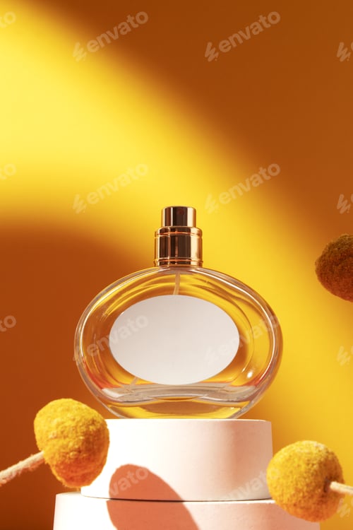 Preview: Perfume bottle with white label and craspedia flowers.