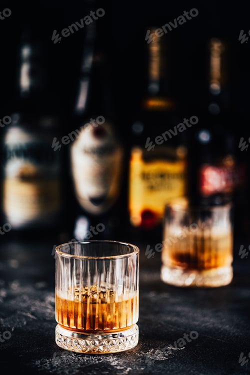 Preview: Whiskey with ice on a dark table