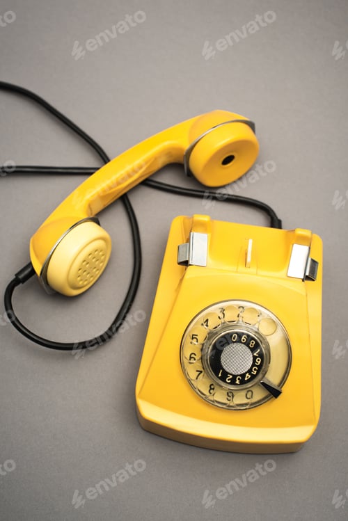 Preview: top view of retro and yellow telephone on grey background