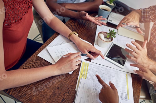 Preview: Cropped shot of a group of colleagues working together at a desk in an office