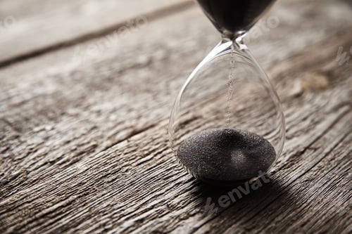 Preview: Hourglass on wooden background, closeup. Urgency and running out of time concept