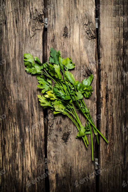Preview: Green parsley. On wooden background.