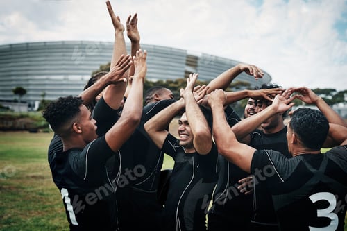Preview: Cropped shot of a team of rugby players celebrating while standing on the field during the day