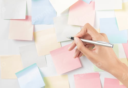 Preview: Hand of businesswoman writing on paper in the office